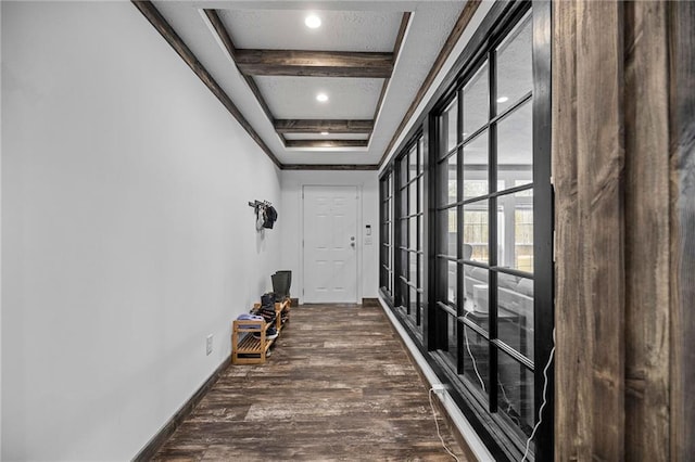 hall with dark hardwood / wood-style flooring and beam ceiling