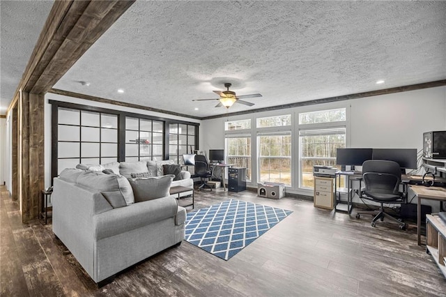 living room featuring crown molding, ceiling fan, dark hardwood / wood-style floors, and a textured ceiling