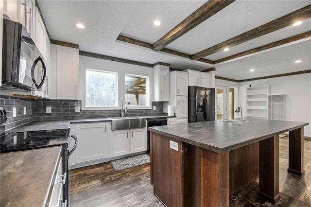 kitchen featuring white cabinets, sink, a kitchen island, and black appliances