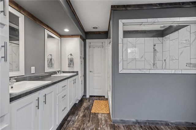 49266 Woodhaven Rd, Tickfaw, LA 70466 - bathroom with walk in shower, double vanity, wood finished floors, and a sink
