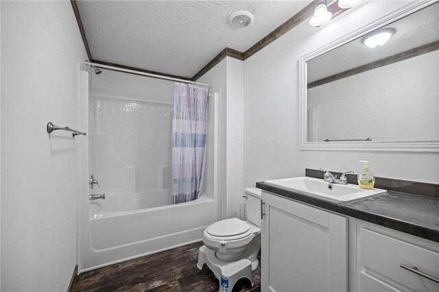 full bathroom with shower / tub combo with curtain, toilet, hardwood / wood-style floors, and a textured ceiling