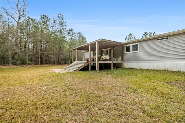 rear view of house featuring a yard