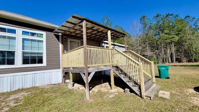 49266 Woodhaven Rd, Tickfaw, LA 70466 - wooden deck featuring a yard and stairway