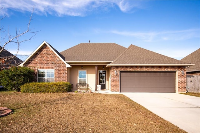 view of front facade with a garage and a front yard