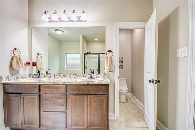 bathroom with tile patterned flooring, vanity, a shower with door, and toilet