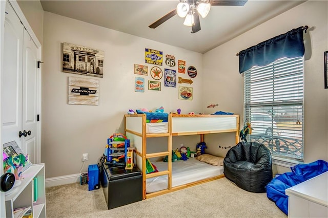 carpeted bedroom with ceiling fan and a closet