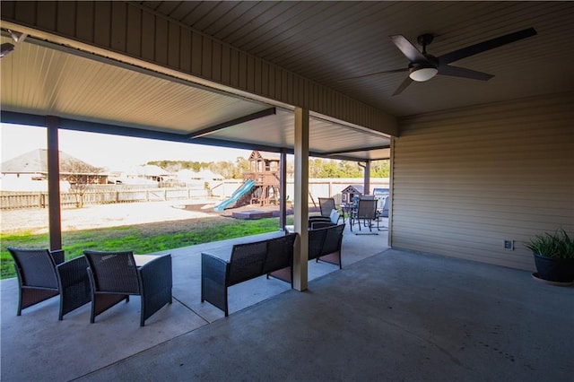 view of patio / terrace with ceiling fan, an outdoor living space, and a playground