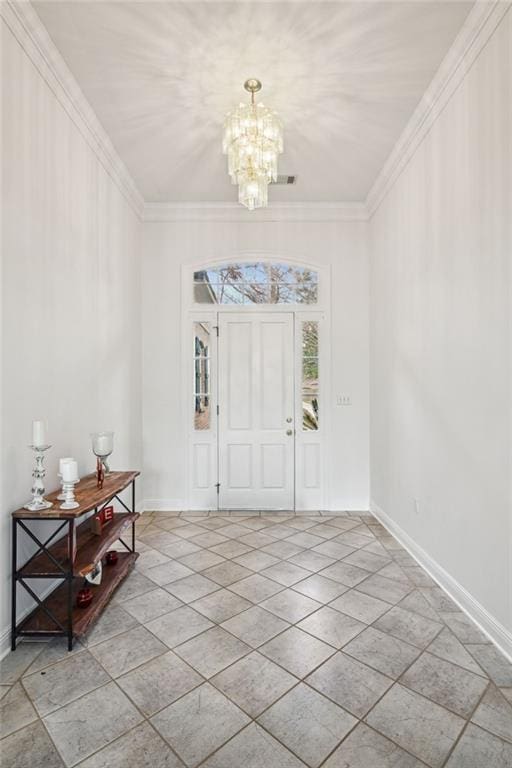 foyer entrance featuring crown molding, light tile patterned floors, and an inviting chandelier