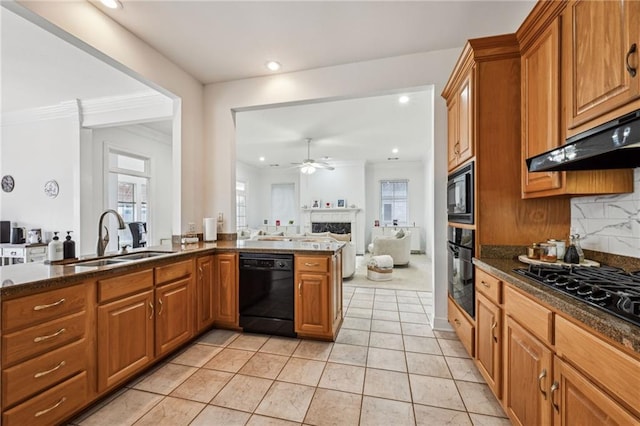 kitchen with sink, backsplash, black appliances, kitchen peninsula, and dark stone counters