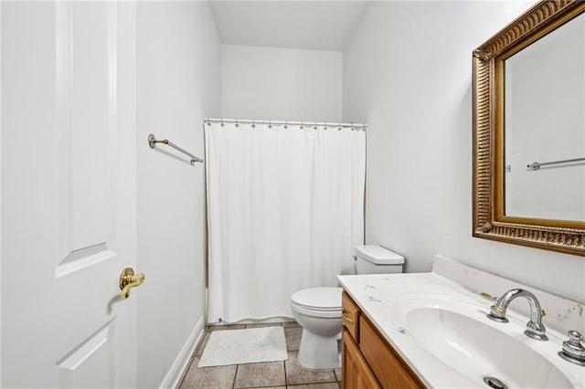 bathroom with tile patterned flooring, vanity, and toilet