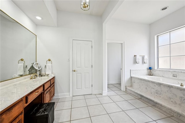 bathroom with tile patterned flooring, vanity, and a bathtub