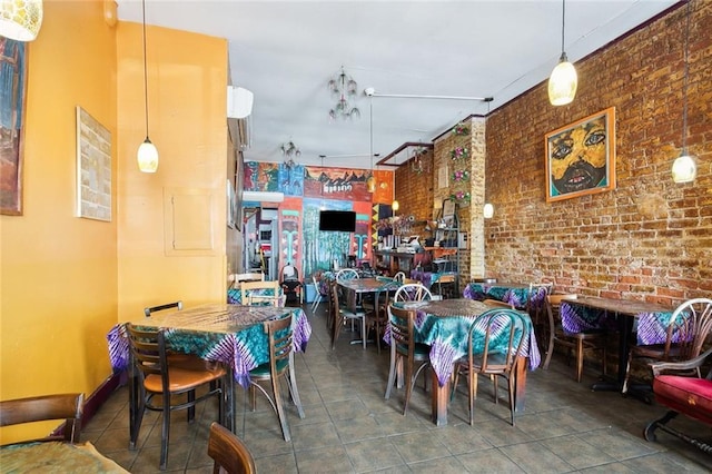 tiled dining room with brick wall