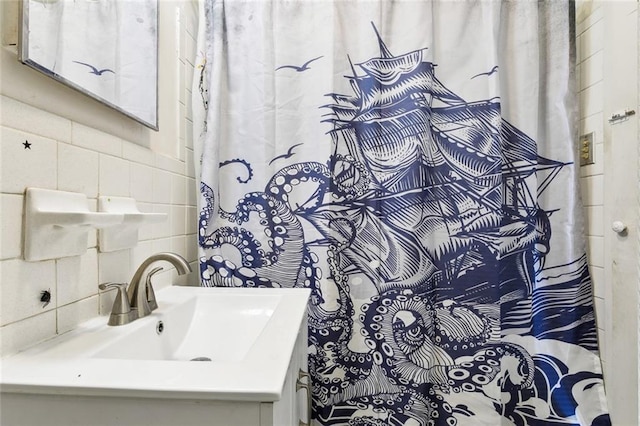 bathroom with tile walls, sink, and decorative backsplash