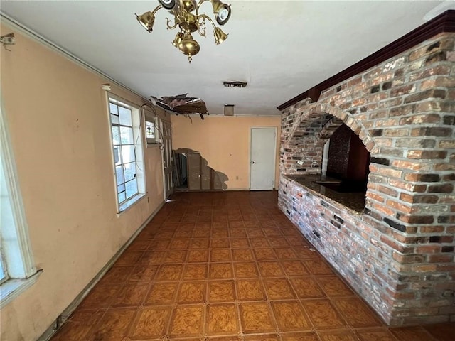 unfurnished living room with brick wall