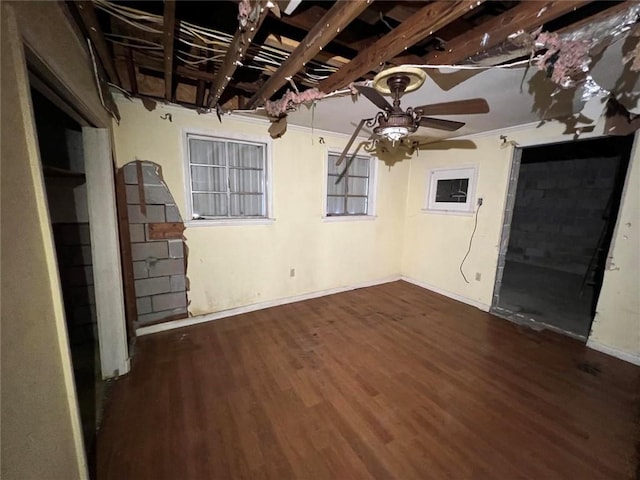 interior space with crown molding, dark wood-type flooring, and ceiling fan