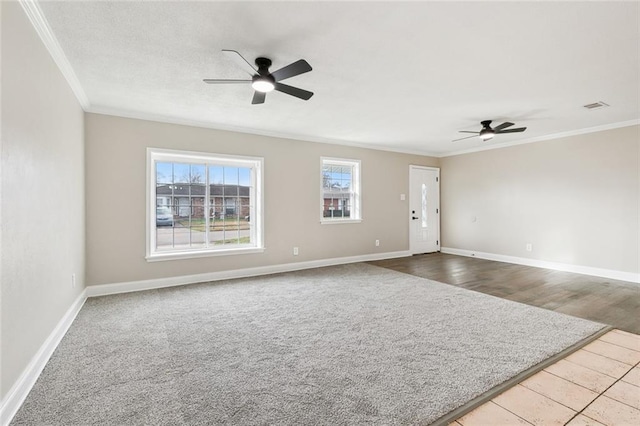 spare room featuring ornamental molding and ceiling fan