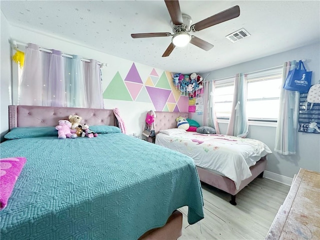 bedroom with light hardwood / wood-style flooring and ceiling fan