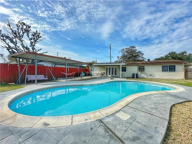 view of pool with a patio and french doors