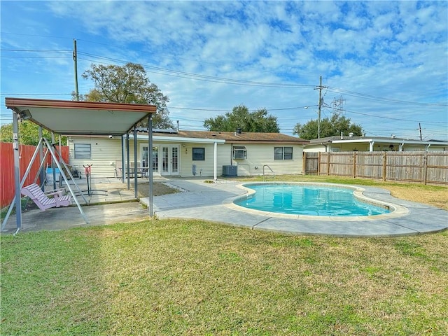 exterior space with a yard, central AC, a patio, and french doors