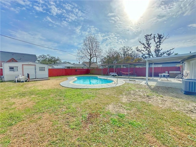 view of pool with a patio, a lawn, central air condition unit, and a shed