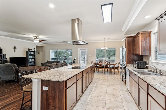 185 Maverick Run, Pearl River, LA 70452 - kitchen featuring crown molding, a center island with sink, a kitchen bar, island exhaust hood, and a sink