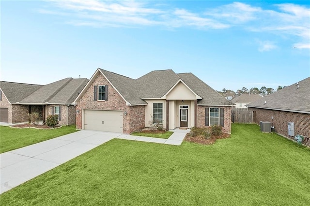 view of front of property with a garage, cooling unit, and a front yard