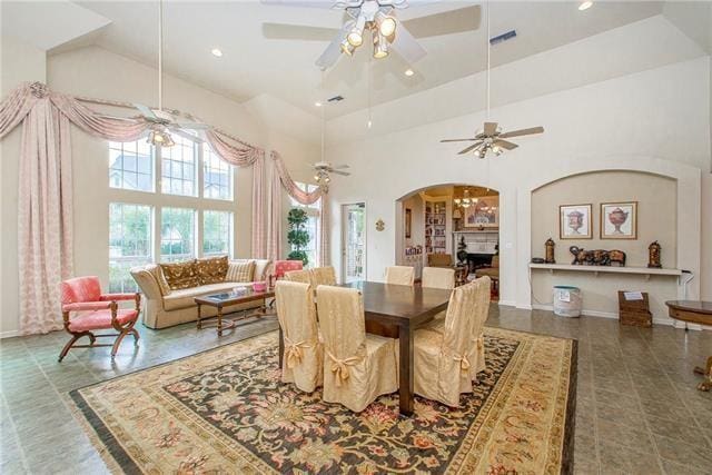 dining room featuring a high ceiling and ceiling fan