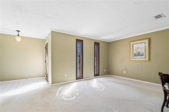 spare room featuring ornamental molding, light carpet, and a textured ceiling