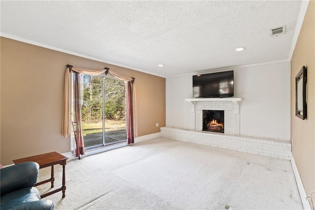 unfurnished living room featuring a fireplace, ornamental molding, carpet flooring, and a textured ceiling