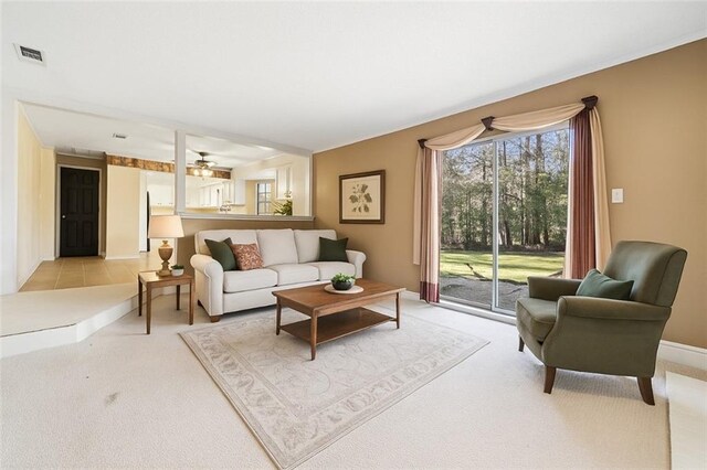 122 Belle Terre Blvd, Covington, LA 70433 - living area featuring light colored carpet, a ceiling fan, and baseboards