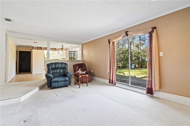 122 Belle Terre Blvd, Covington, LA 70433 - living area featuring carpet, ornamental molding, a textured ceiling, baseboards, and a ceiling fan
