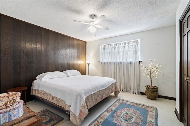 122 Belle Terre Blvd, Covington, LA 70433 - bedroom featuring wood walls, ceiling fan, and a textured ceiling