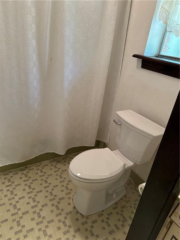 122 Belle Terre Blvd, Covington, LA 70433 - bathroom with toilet, tile patterned floors, and a shower with curtain