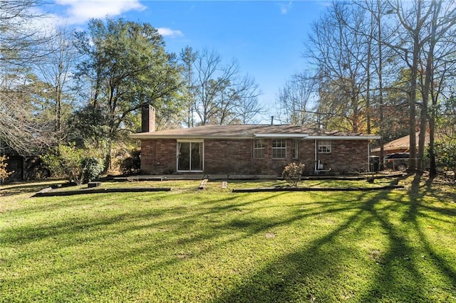 122 Belle Terre Blvd, Covington, LA 70433 - back of house with a chimney, a yard, and brick siding