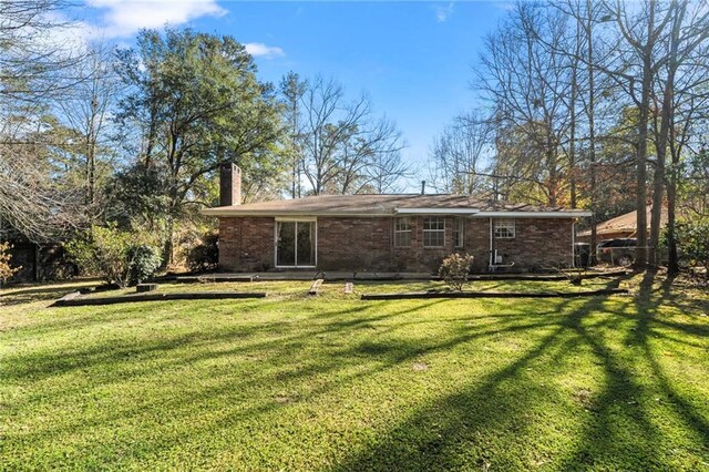 122 Belle Terre Blvd, Covington, LA 70433 - view of green lawn featuring a garage and driveway