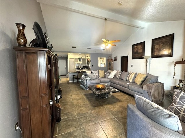 living room featuring vaulted ceiling with beams, a textured ceiling, and ceiling fan