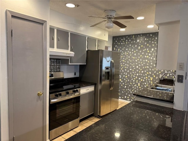 205 Hollow Rock Ct, Slidell, LA 70461 - kitchen featuring appliances with stainless steel finishes, under cabinet range hood, a sink, a ceiling fan, and light tile patterned floors