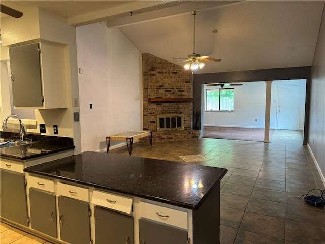 205 Hollow Rock Ct, Slidell, LA 70461 - kitchen with a ceiling fan, open floor plan, dark tile patterned flooring, and a fireplace