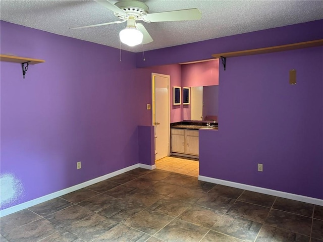 205 Hollow Rock Ct, Slidell, LA 70461 - unfurnished room with ceiling fan, a textured ceiling, and baseboards