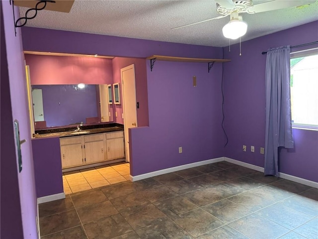 205 Hollow Rock Ct, Slidell, LA 70461 - empty room featuring a sink, ceiling fan, baseboards, and a textured ceiling