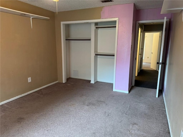205 Hollow Rock Ct, Slidell, LA 70461 - unfurnished bedroom featuring carpet, a textured ceiling, and a closet