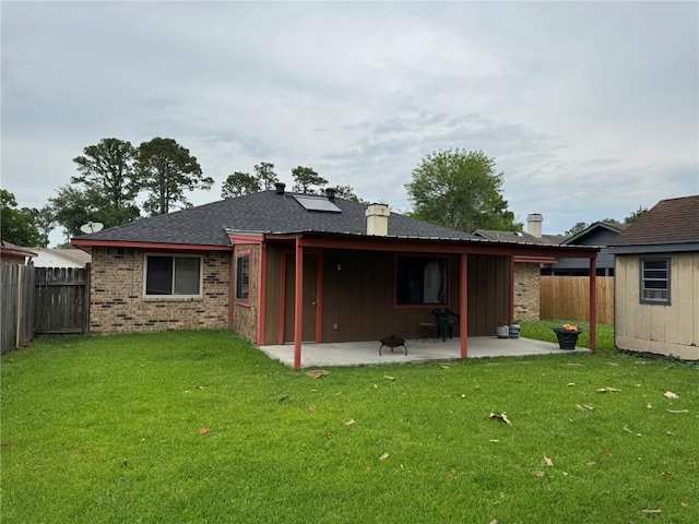 205 Hollow Rock Ct, Slidell, LA 70461 - back of property with a patio, brick siding, a chimney, a shingled roof, and board and batten siding