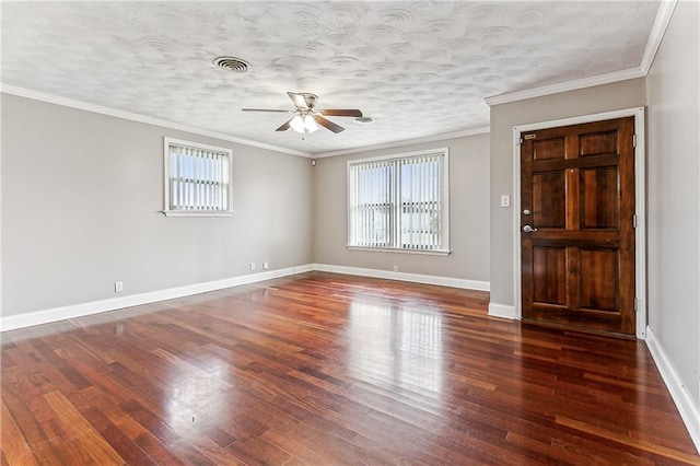 spare room featuring ornamental molding, dark hardwood / wood-style floors, and a textured ceiling