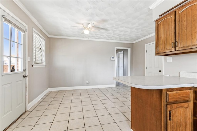 kitchen featuring crown molding, light tile patterned floors, ceiling fan, and kitchen peninsula