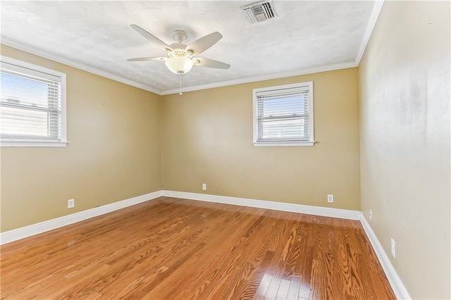 spare room with hardwood / wood-style flooring, ceiling fan, and crown molding