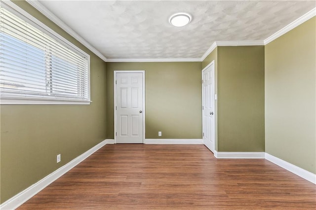 unfurnished bedroom with ornamental molding and dark hardwood / wood-style flooring