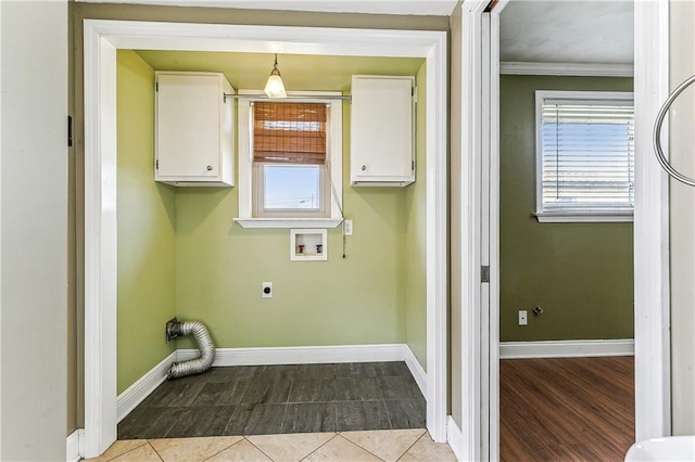 laundry room with cabinets, electric dryer hookup, washer hookup, and light tile patterned floors