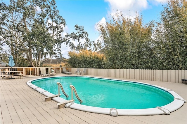 view of swimming pool with a wooden deck