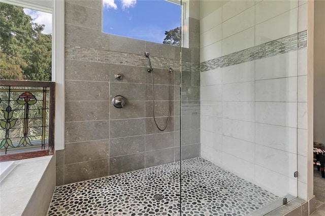 bathroom with a tile shower