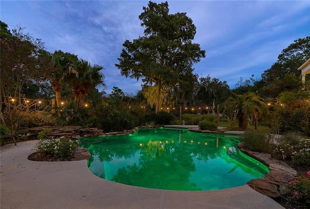 view of pool at dusk